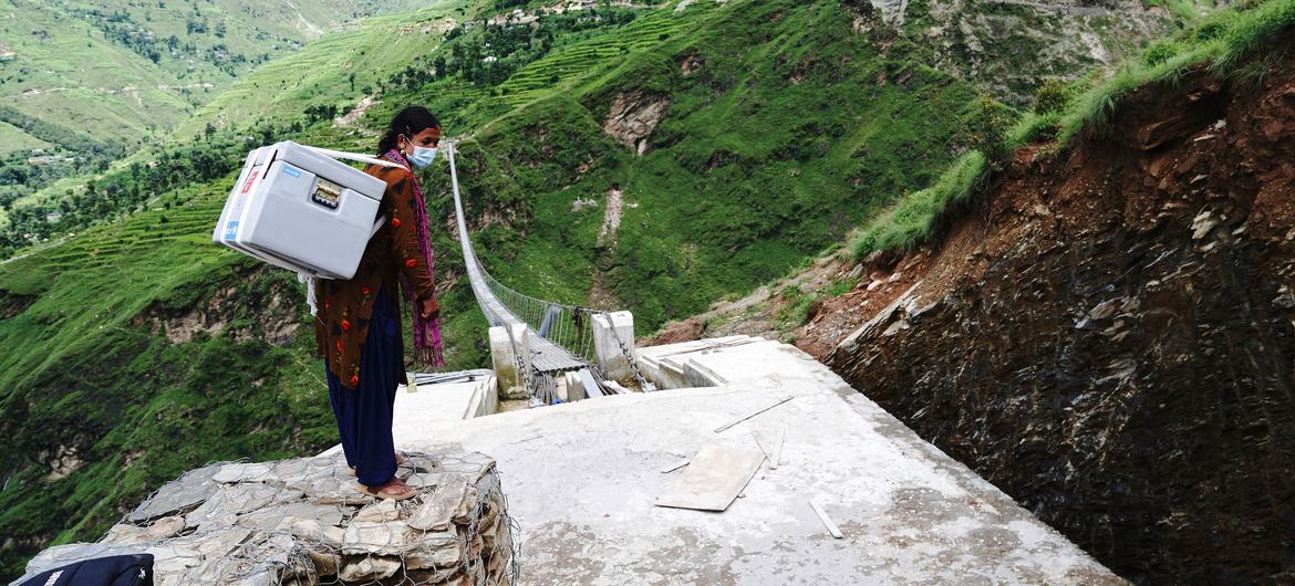 A health worker delivers COVID-19 vaccines, donated through the COVAX Facility, to a Health Post in Nepal