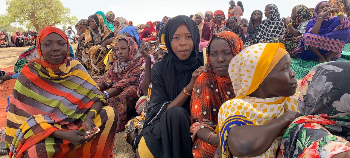 Refugees from Sudan wait to collect aid items in a border village in Chad. Refugees from Sudan wait to collect aid items in a border village in Chad.