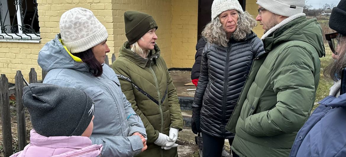 The Humanitarian Coordinator and Head of the United Nations in Ukraine, Denise Brown (centre right), talks to residents of Hroza on the frontline in Ukraine. The Humanitarian Coordinator and Head of the United Nations in Ukraine, Denise Brown (centre right), talks to residents of Hroza on the frontline in Ukraine.