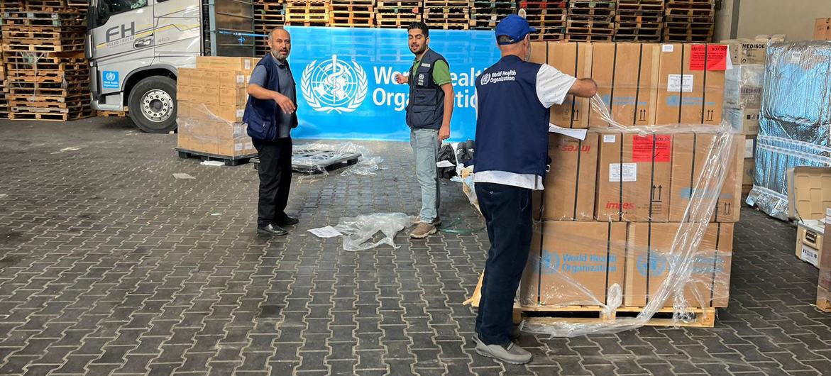 Medical supplies organized by WHO are unloaded in a warehouse in Gaza. Medical supplies organized by WHO are unloaded in a warehouse in Gaza.