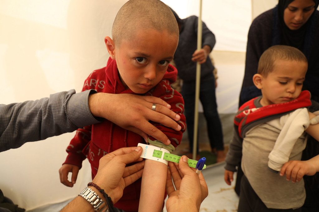 Mohammad is getting measured as part of a malnutrition screening at a UNICEF-supported pediatrician clinic tent in Rafah city, south of the Gaza Strip. Mohammad is getting measured as part of a malnutrition screening at a UNICEF-supported pediatrician clinic tent in Rafah city, south of the Gaza Strip.