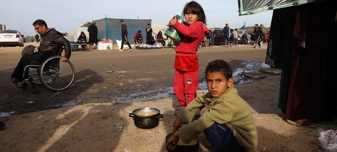 Displaced children search for food near the tents where they are staying with their families in Rafah in southern Gaza. Displaced children search for food near the tents where they are staying with their families in Rafah in southern Gaza.