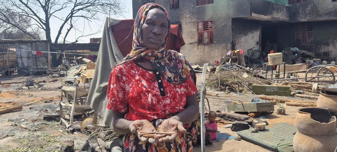 A woman holds gun shells discharged in fighting in West Darfur.