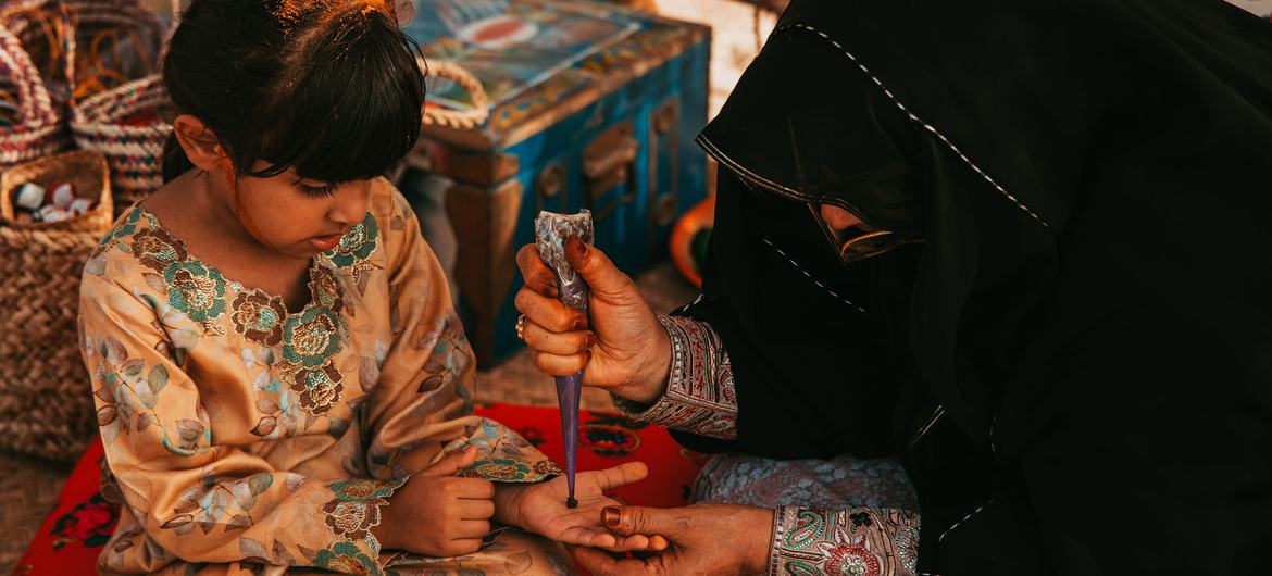 Applying henna in celebration of Eid, United Arab Emirates. Applying henna in celebration of Eid, United Arab Emirates.