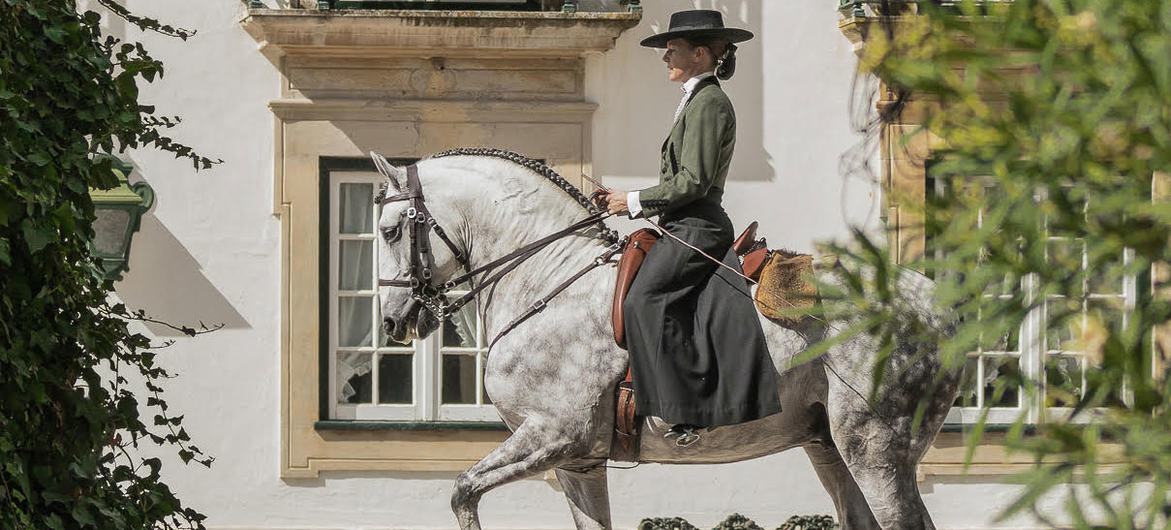 Female horse rider in Golegã dressed in Portuguese style. Female horse rider in Golegã dressed in Portuguese style.
